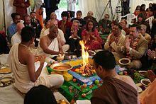 Brahmins in North West London, joined by Brent and Harrow politicians, in white dress performing the Bhumi Puja ritual yajna around fire (A) Bhumi Puja, yajna.jpg