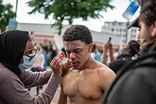 Street medics tend to a protester sprayed with chemical irritants in Minneapolis, May 27, 2020. 5-27-2020 (22 of 61) (49944144822).jpg