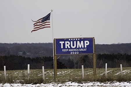 A Trump sign and torn US flag flying after the election near St Croix Falls, Wisconsin