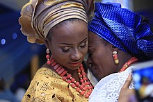 A Yoruba bride hugs her mother on her traditional wedding day. This is a farewell hug from mother to daughter. A Yoruba bride and mother.JPG