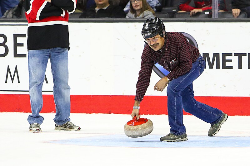 File:A fan doing a curling promotion between periods (23279844561).jpg