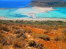 Balos coastal lagoon of northwestern Crete. The shallow lagoon is separated from the Mediterranean sea by narrow shoals connecting to a small, rocky mountain. BalosLagoonCreta.jpg