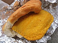 A Jamaican patty wrapped in coco bread.