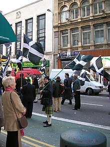 The Cornish flag being flown in a parade Cornish at Gwyl Dewi.jpg