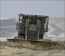 IDF Caterpillar D9 armored bulldozer clearing mines in the Jordan Valley. D9-Magov-Ratzif.jpg