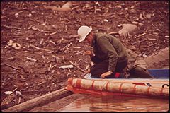 EPA MAN CHECKS LOG BOOM FOR LEAKAGE OF OIL AND DEBRIS FOLLOWING A MASSIVE OIL SPILL INTO THE SAN JUAN RIVER. ORIGIN... - NARA - 545663.jpg