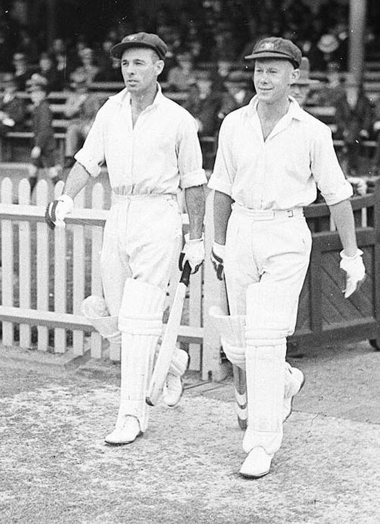 Jack Fingleton (left) and Brown walk to the crease to open for Australia during a Test against England in 1936–37.