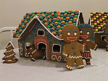 Gingerbread man (styled after The Gingerbread Man from Shrek) with his wife and dog in front of a gingerbread house Gingerbread landscape.jpg