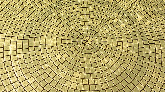 Closeup of the many golden mosaic pieces that make up the large outer discs of Matrimandir in Auroville, India.