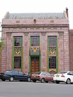 Elmslea Chambers in Goulburn, New South Wales, Australia - built in 1933, it was one of the first buildings in Australia to use coloured polychrome terracotta in its facade which features a fine relief of birds, flowers, leaves and typical Art Deco sunbursts under the windows. GoulburnElmsleaChambers 001.jpg