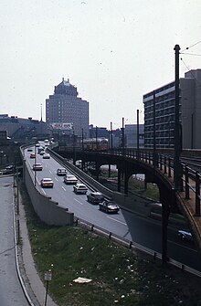 A Lechmere-bound PCC streetcar train on the Causeway Street elevated in May 1976, next to Central Artery ramps Green Line trolley next to Central Artery 2.jpg