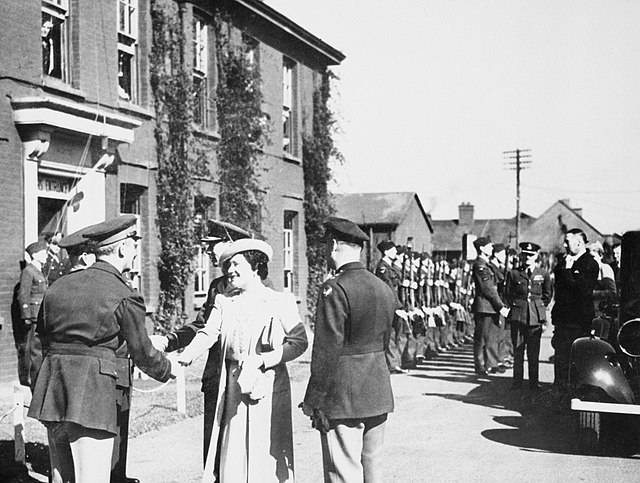 H.M. King George VI and Queen Elizabeth are greeted by Major General Frank Hunter and Major General Ira C. Eaker of the 8th U.S. Army Air Forces on th