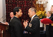 Jacob Rajan (left), at his investiture as a Member of the New Zealand Order of Merit, for services to theatre, by the governor-general, Sir Jerry Mateparae, on 23 May 2013 Jacob Rajan MNZM investiture.jpg