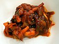 한국어: 오징어 젓갈 English: Ojingeo jeotgal, made with shredded squid, chili pepper powders
