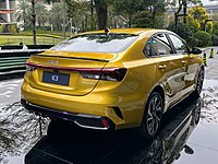 Kia K3 III facelift on display, yellow, rear quarter.jpg