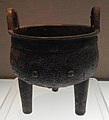 Bronze round tripod with animal mask decoration