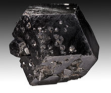 Crystals of melanite, a variety of andradite garnet. Melanite-Mali.jpg