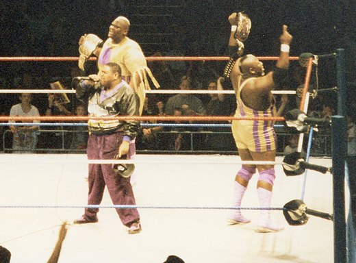 Mo (right) and Mabel (center) celebrating with Oscar (left) upon winning the WWF World Tag Team Championship in 1994.