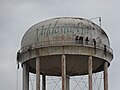 Men working on Savannah Ave water tower preparing for dismantling