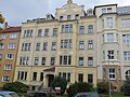 Apartment house in closed development with front garden and enclosure wall