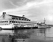 Naval Reserve Armory Seattle with USS Waxbill (AMS-39) circa in 1950.jpg
