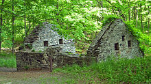 This former Laflin & Rand powder mill building illustrates the protective stone walls on three sides after the weaker wooden back wall and roof have rotted away. Orange Powder Mill ruins.jpg