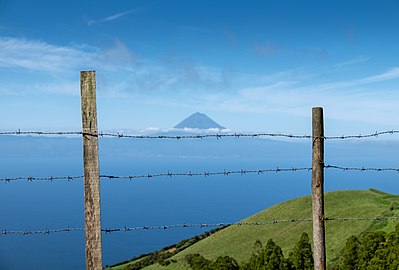 Pasture fence with the Pico Mountain in the background, São Jorge, Azores, Portugal