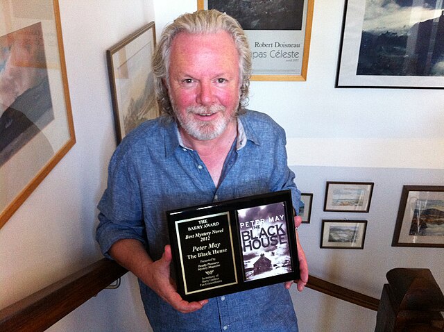 Peter May with the 2013 Barry Award for Novel, for his book, "The Blackhouse".