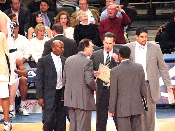 Head coach Jamie Dixon (clipboard) huddles with his coaching staff in 2007