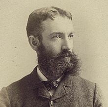 Photograph of a young and bearded DeLancey W. Gill, showing head and shoulders.