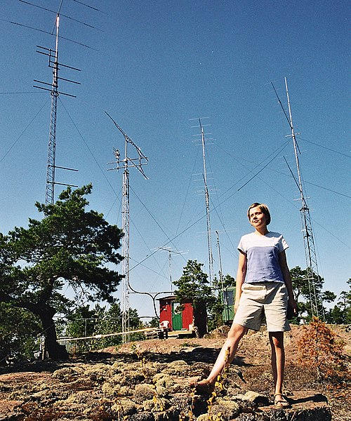 A young woman wearing t-shirt and shorts at the warm summer in Åland