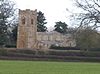 A stone church with a battlemented tower