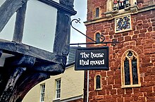 The sign on the house with the Church of St Mary Steps opposite The House That Moved sign.jpg