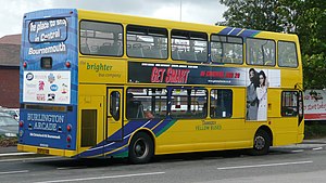 A bus with a full rear surface advert, and a side panel advert fitted in special guides Transdev Yellow Buses 114 rear.JPG