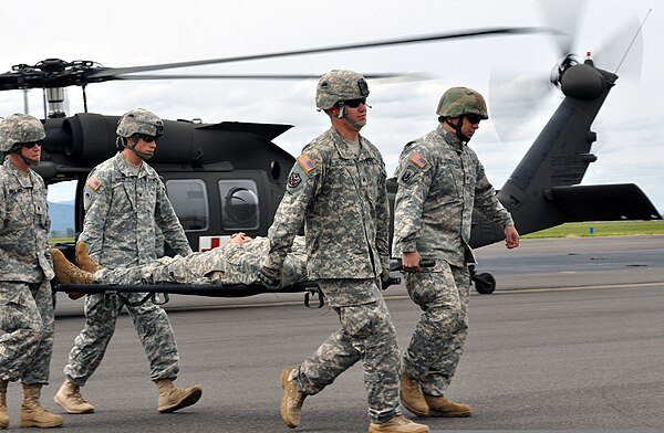Oregon National Guardsmen simulating the evacuation of a casualty during a training exercise