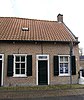 Huis in gele baksteen onder dwars zadeldak