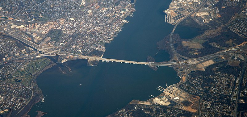 2012 aerial view of Wilson Bridge and its environs. Alexandria, Virginia, is to the left and Oxon Hill, Maryland, is to the right, with National Harbor, Maryland, at bottom right. The Blue Plains section of DC is in the upper center-right portion. Woodrow Wilson Bridge aerial 2012.jpg