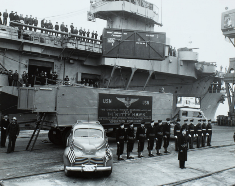 File:Wright Bros original airplane "Kitty Hawk", 1of3 crates, unloaded from USS Palau at Bayonne-NY Naval Shipyard annex on Operation Homecoming, London to DC, Nov 19, 1948.png