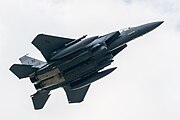 An F-15E Strike Eagle, tail number 91-0302, taking off from RAF Lakenheath in England. The aircraft is assigned to the 492nd Fighter Squadron.