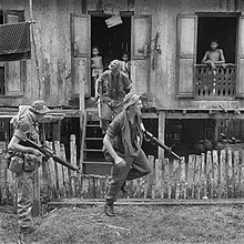 4 RAR soldiers moving through a Malaysian village near the border with Indonesia in June 1966 4 RAR soldiers operating in a Malaysian village during the Indonesian Confrontation.jpg