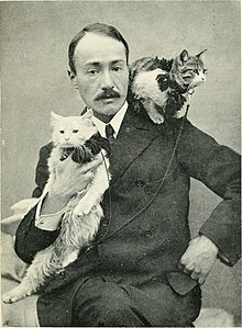 Arnold Henry Savage Landor with his two Persian kittens, which he purchased himself in Kerman, Iran (known then as Persia) around 1900 Across coveted lands - or, A journey from Flushing (Holland) to Calcutta, overland (1903) (14801328343).jpg