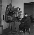 An employee working with a press machine in Yleisradio's workshop, March 1946. (15301020549).jpg