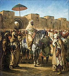 Romantisch oriëntalistisch schilderij van een militaire leider te paard, omringd door zijn mannen, voor imposante muren