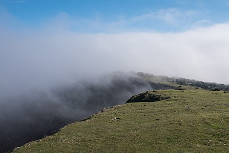 Fog breaking up at Ganalto summit, Badaia mountain range. Basque Country, Spain