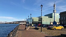 The Beacon Arts Centre, with the Gallery Suite and cafe / bistro looking out over the Custom House Quay waterfront and the Clyde. Beacon Arts Centre & clock tower w.jpg