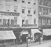 Photo of 483, 485, and 487 Broadway, with the entrance to, and name of, the Broadway Theatre; a sign reading "Matinee"; and posters announcing Julia Dean in The Woman in White. Also visible are signboards of H. F. Shepher (Essex Hat Manufacturing Co.) at 483, H. Knighton and Alfred Plunkett at 485, and Lasell & Co. (hats) at 487.
