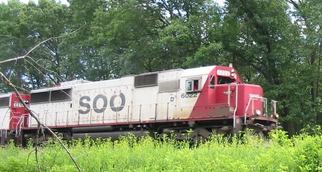 Soo Line 6022, an EMD SD60, pulls a train through Wisconsin Dells on June 20, 2004.