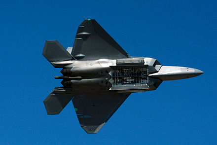 For stealth, the F-22 carries weapons in internal bays. The doors for the center and side bays are open; the six LAU-142/A AMRAAM Vertical Eject Launchers (AVEL) are visible.