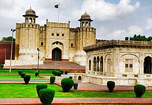 The iconic Alamgiri Gate of the Lahore Fort was built in 1674 and faces Aurangzeb's Badshahi Mosque. Fort of Lahore.jpg