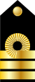 Τρεις χρυσές ισοπαχείς λωρίδες, εκ των οποίων η πρώτη συστρέφεται στη μέση και σχηματίζει κύκλο. Μαύρο υπόβαθρο.